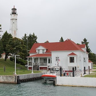 A white lighthouse at the lakefront.