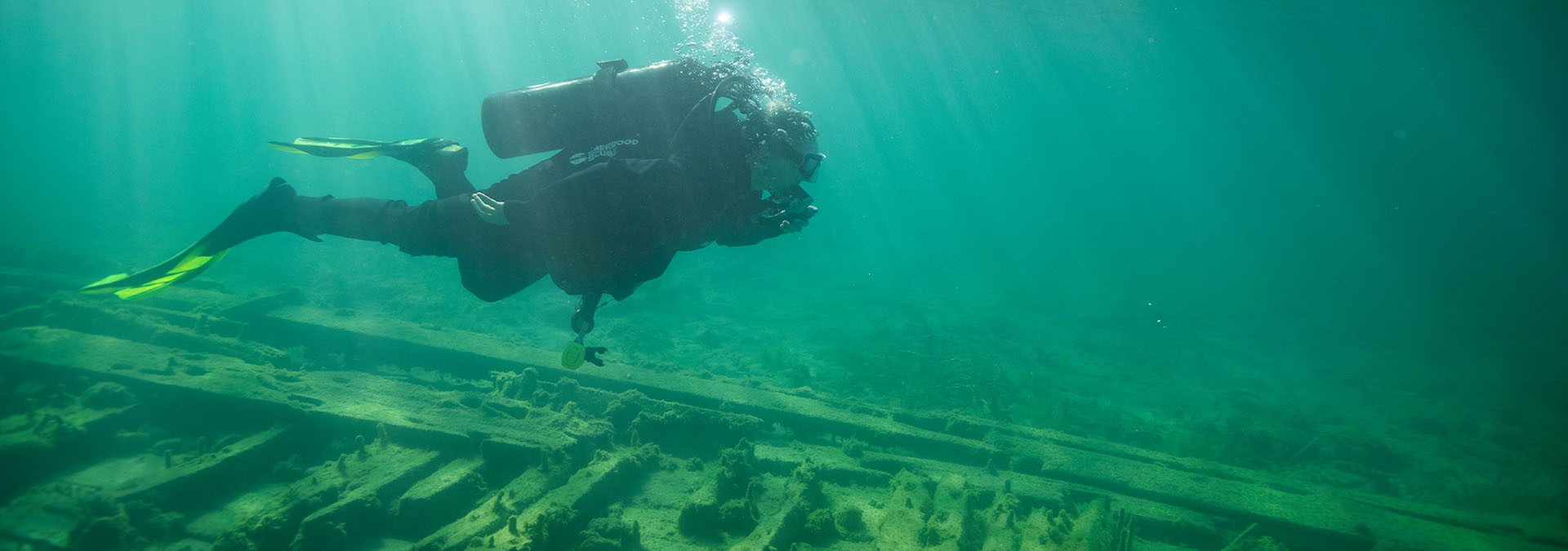 A person scuba diving around a shipwreck