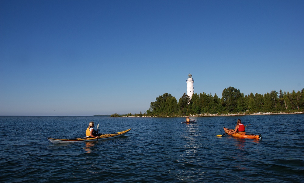 Kayakers in front of Cana Island lighthouse.