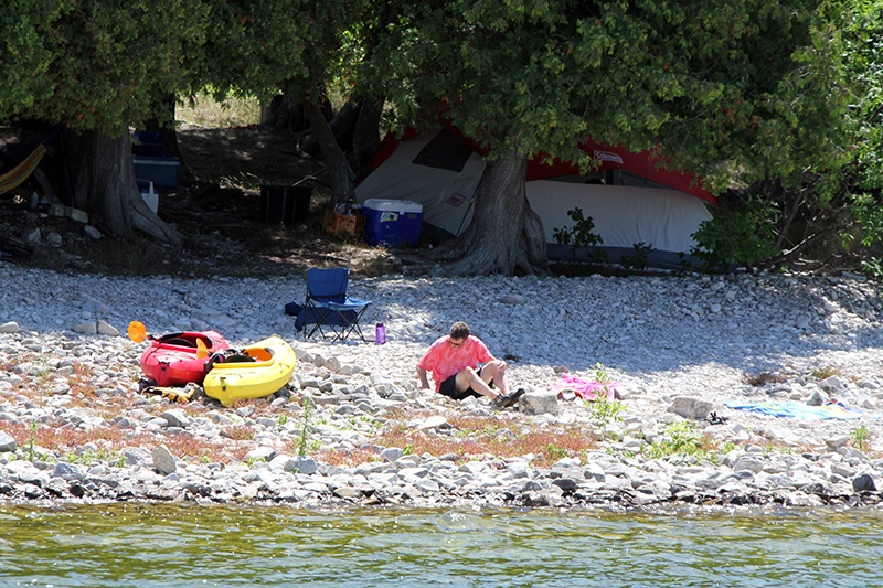 Kayakers camping on the shore of the lake