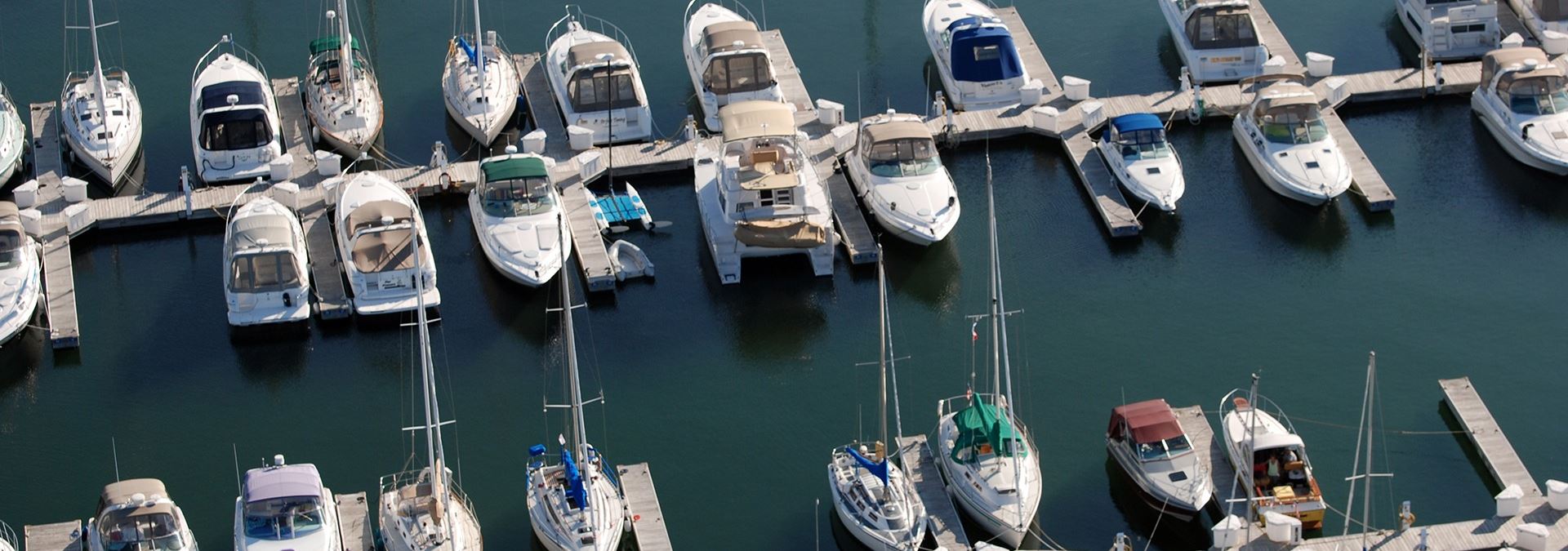 Sailboats docked in a marina from above.