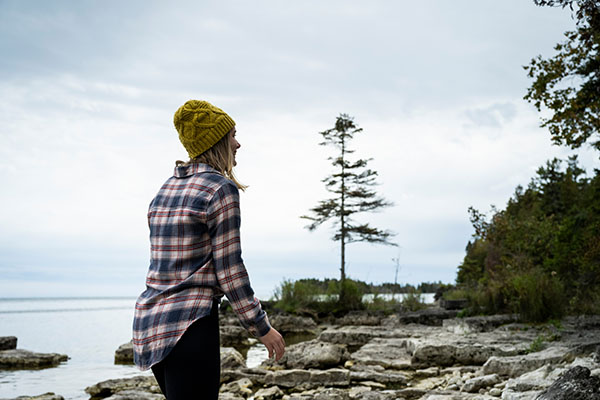 A woman hikes along the shoreline at Toft Point.