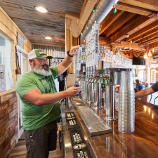 Man pouring a tap beer at the bar.
