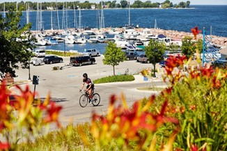 Cyclist riding in front of the marina