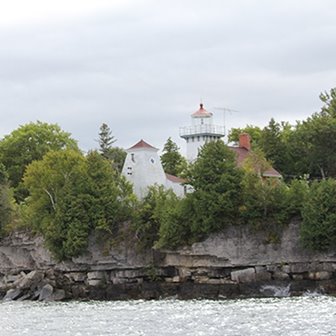 Sherwood Point lighthouse on a cliff at the edge of the lake.