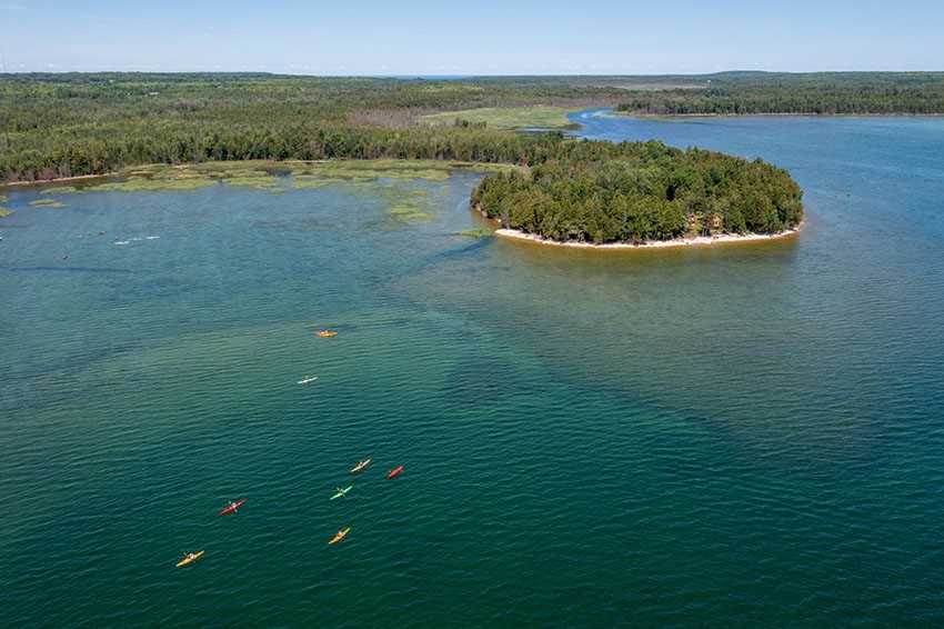 Aerial view of kayakers heading toward land