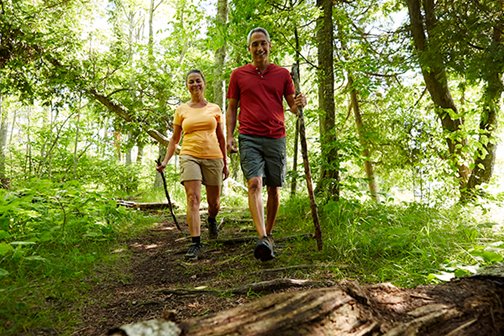 A couple hiking on a wooded trail