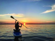 A kayaker on the lake at sunset.