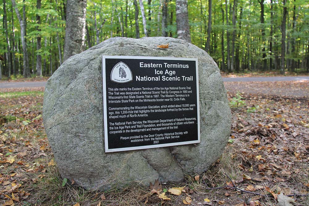 Black plaque on rock with wooded background