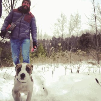 A guy and his dog in the snow