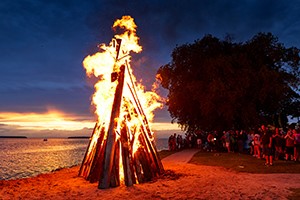 People watching a large bonfire.