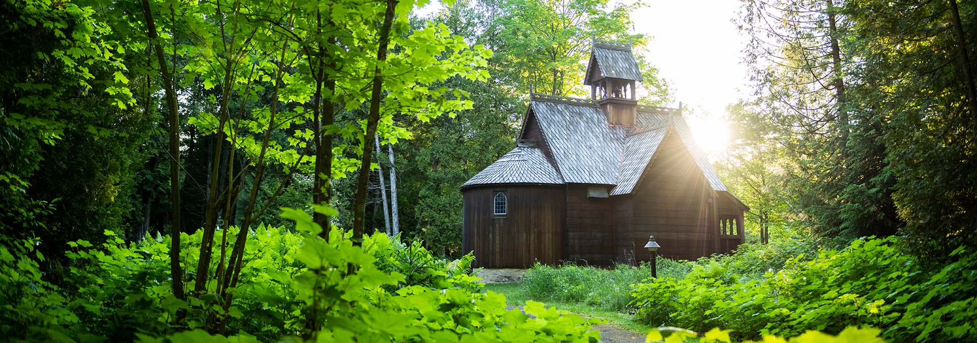 Wooden church surrounded by trees.