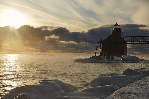 The iconic red lighthouse during a stunning sunrise.