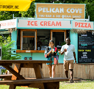 A couple getting refreshments at Pelican Cove Tiki Bar and Ice Cream Shack.