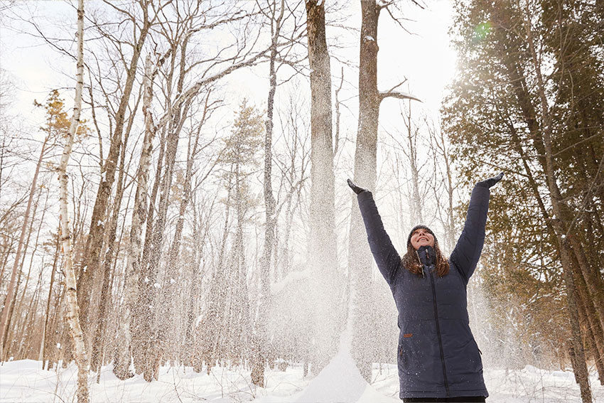 Woman throwing snow in the air at Peninsula State Park.