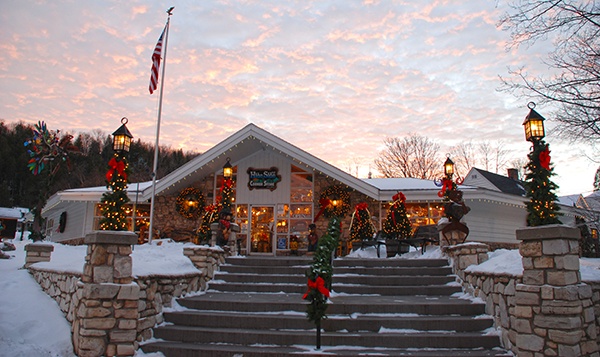 Exterior of a brightly lit holiday store at sunset