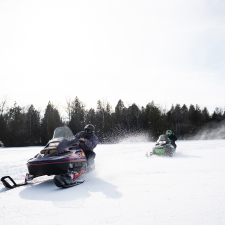 People snowmobiling
