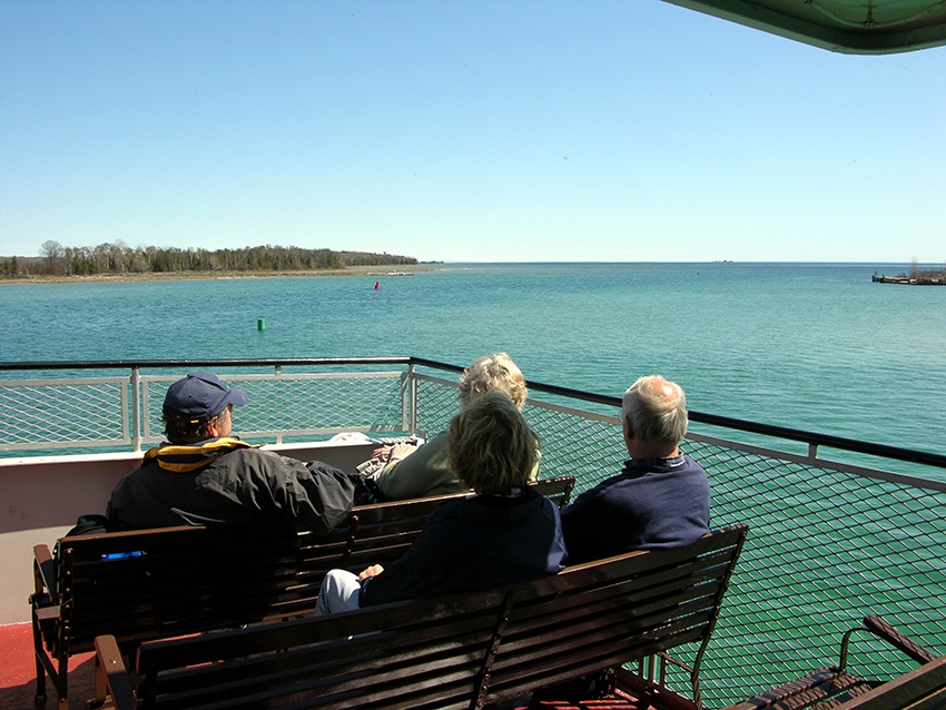 A group looks out at the vastness of Lake Michigan from the ferry deck