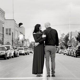 Couple looking into each others eyes in the middle of the road.