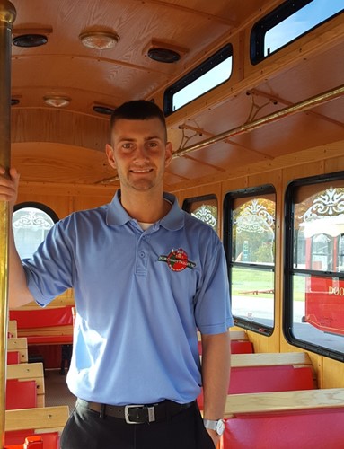 John Bartzen poses inside a trolley car.