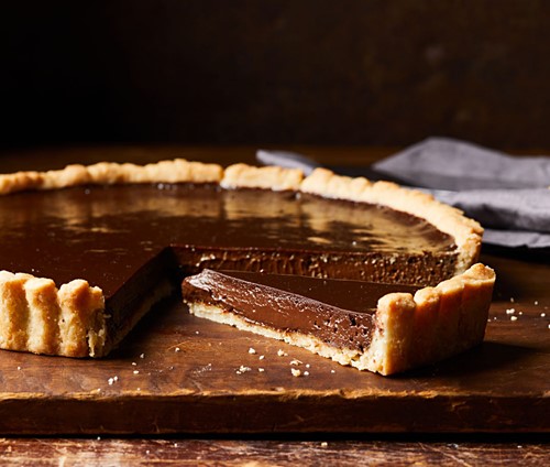 Chocolate pie tart with a slice cut out