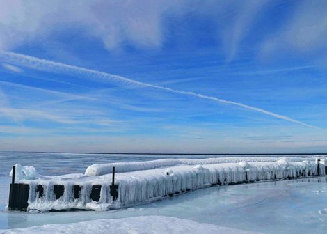 An ice-covered pier at the lake.