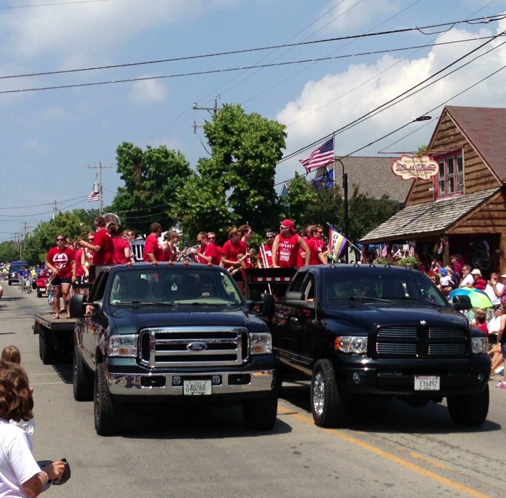 Two trucks leading a parade.