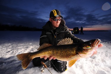 A ice fisherman shows off his giant catch.