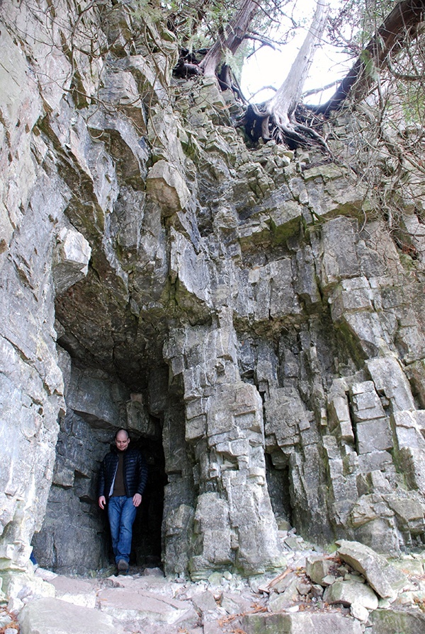Person standing in stone escarpment