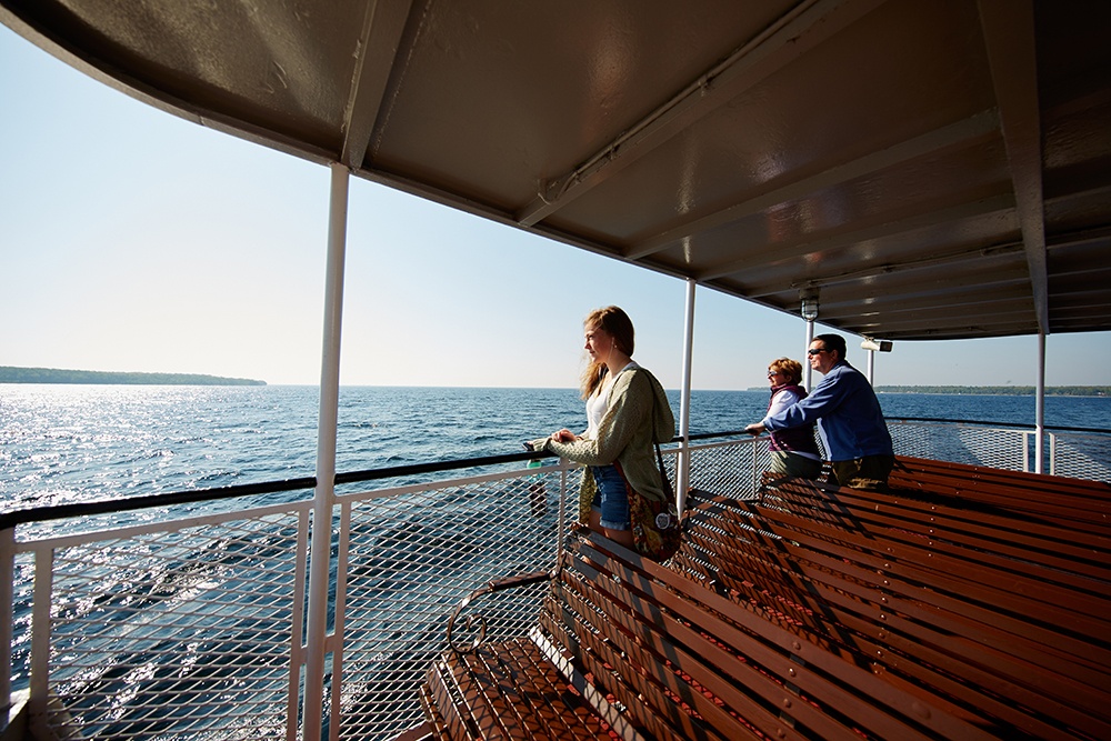 Visitors ride the Washington Island ferry across Lake Michigan at sunset.