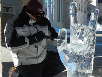 A man carving an ice sculpture