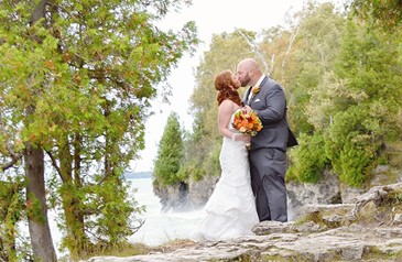 Bride and groom kissing on an overlook