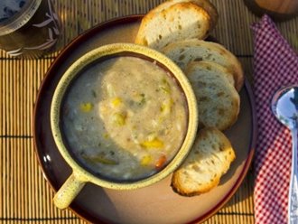 A bowl of chowder soup and bread