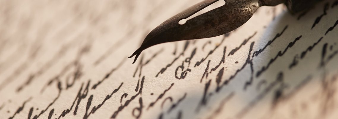 A closeup of a fountain pen writing script
