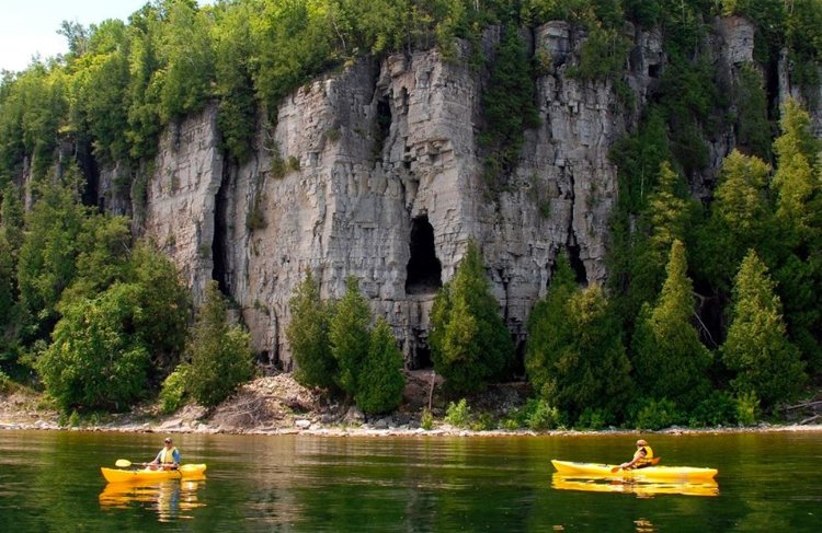 Kayakers paddling below Niagara Escarpment.