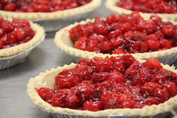 Unbaked cherry pies wait to go into the oven.