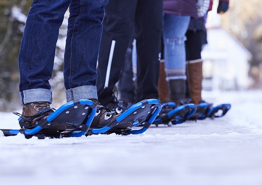 A closeup of people wearing snowshoes.