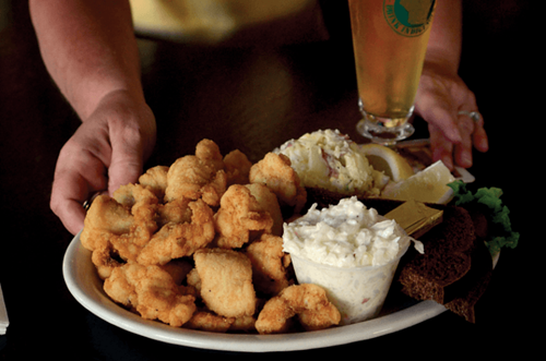 A plate of deep-fried lawyer with sides and a beer.