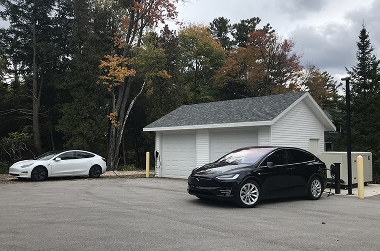 Cars parked next to a white building.