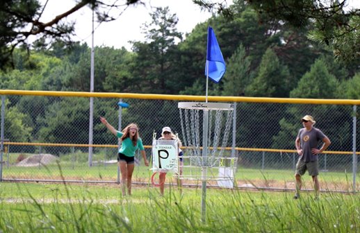 People playing disc golf.