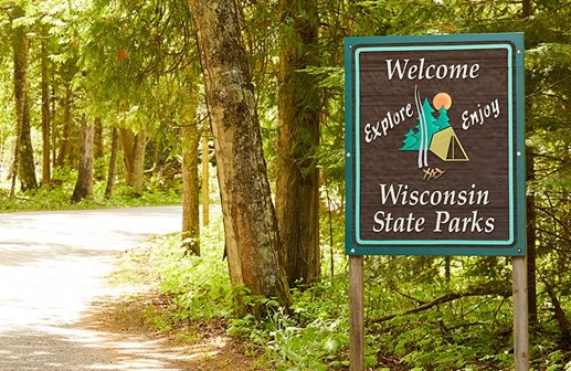 Wisconsin State Parks sign in front of trees.