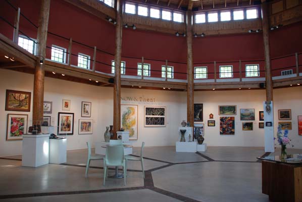 Interior of the Kress Pavilion with walls lined with art.