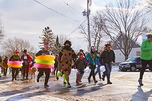 People dressed up in costumes running a race