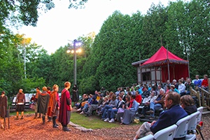 Actors performing in front of a crowd.