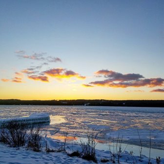 Sunrise over the snowy frozen lake.