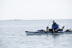 A person fishing off of a small boat