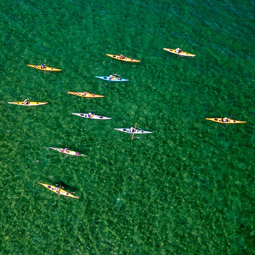 Aerial view of a group of kayaks on the lake.