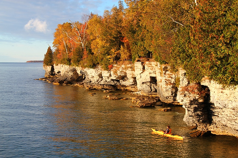 Kayakers in front of the Niagara Escarpment in fall