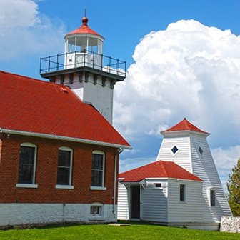 Sherwood Point lighthouse with clouds in the background.