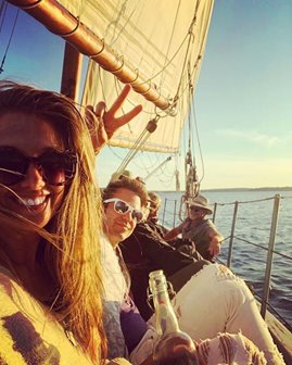 From the point of view of people taking a selfie while having a good time sitting on a sailboat